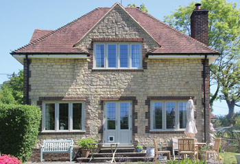 Recessed Edwardian timber casement windows in French Grey for this picturesque Country Cottage in Wormley, Surrey