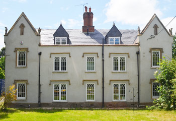 New and replacement Recessed timber casement windows with arched glazing bars for this exceptional country House in Churt, Farnham